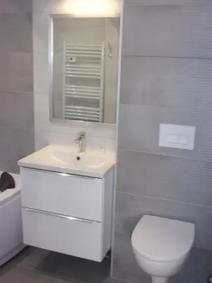 a bathroom with a sink and a toilet and a mirror at Le bourget - Suite romantique in Narbonne
