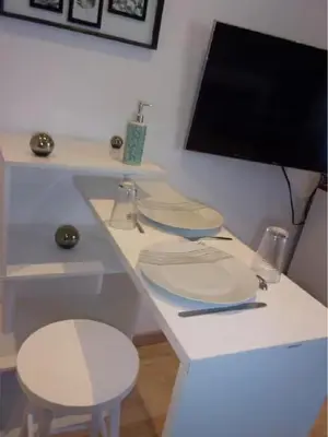 a white desk with two stools and a computer monitor at Le bourget - Suite romantique in Narbonne