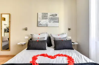 a bedroom with a bed with a red heart on it at Le Bourget - Envolée Romantique in Narbonne