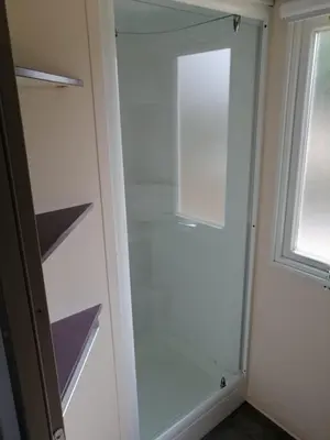 a glass walk in closet with a window at Mobil Home climatisé 6 personnes in Port-la-Nouvelle