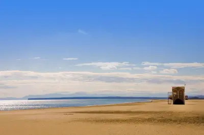 a beach with a wooden structure on the beach at Mobil Home climatisé 6 personnes in Port-la-Nouvelle