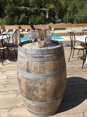 a table with a cup of coffee and flowers on it at Camping La Bernede in Rennes-les-Bains
