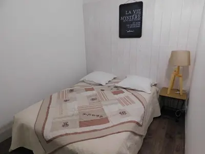 a bedroom with a bed with a quilt on it at LA MAISON DU LAC climatisée et WiFi gd F3 in Port-la-Nouvelle