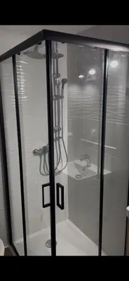 a glass shower stall with a sink and a shower at LA MAISON DU LAC climatisée et WiFi gd F3 in Port-la-Nouvelle