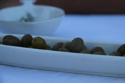 a tray filled with black balls on a table at Mas des 4 Vents in Fitou