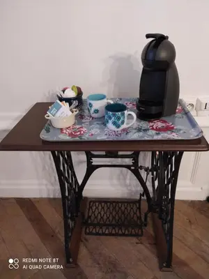 a table with a tea pot and cups on it at Le 9 de Cour, Chambre Chaco in Carcassonne