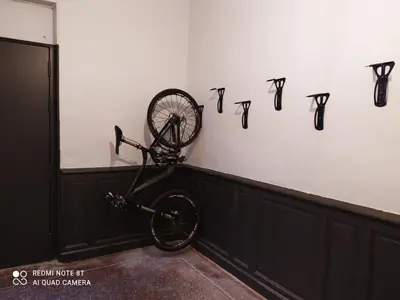 a bicycle is hanging on a wall with numbers on it at Le 9 de Cour, Chambre Chaco in Carcassonne