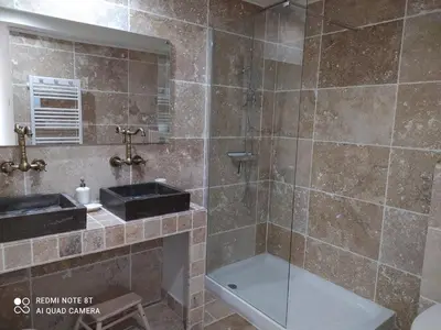a bathroom with a shower and a sink and a tub at Le 9 de Cour, Chambre Chaco in Carcassonne