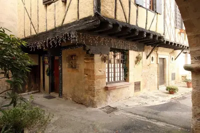an old stone building with a window on a street at MAISON DE NOSTRADAMUS*** OCCITANIE INSOLITE in Alet-les-Bains