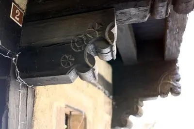 a close up of a wooden box with bells on a building at MAISON DE NOSTRADAMUS*** OCCITANIE INSOLITE in Alet-les-Bains