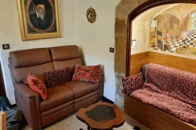 a living room with a couch and a table at MAISON DE NOSTRADAMUS*** OCCITANIE INSOLITE in Alet-les-Bains