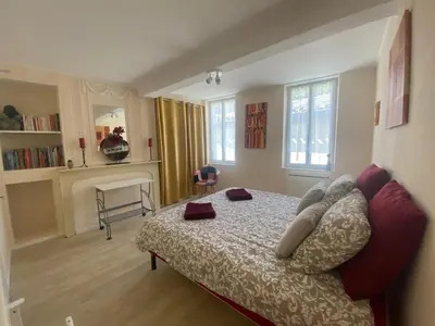 a bedroom with a bed and a chair in it at Chambre privée au calme excellente prestation in Castelnaudary