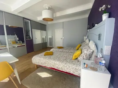 a bedroom with a bed with yellow pillows on it at Chambre privée au calme excellente prestation in Castelnaudary