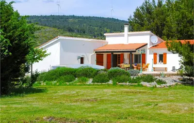 a white house with a yard in front of it at Cozy Home In Pouzols-Minervois in Pouzols-Minervois