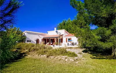 a white house with trees and a yard at Cozy Home In Pouzols-Minervois in Pouzols-Minervois