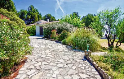a stone path in front of a house at Cozy Home In Pouzols-Minervois in Pouzols-Minervois