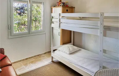 a room with two bunk beds and a window at Cozy Home In Pouzols-Minervois in Pouzols-Minervois