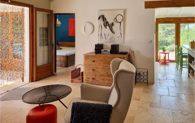 a living room with two chairs and a table at Cozy Home In Pouzols-Minervois in Pouzols-Minervois