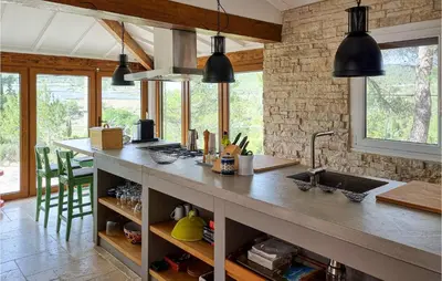 a kitchen with a counter with a sink and windows at Cozy Home In Pouzols-Minervois in Pouzols-Minervois