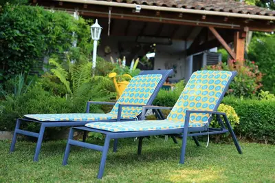 two chairs sitting on the grass in a yard at A l'Ecole Buissonnière, chambre d'hôtes en Sidobre in Lacrouzette