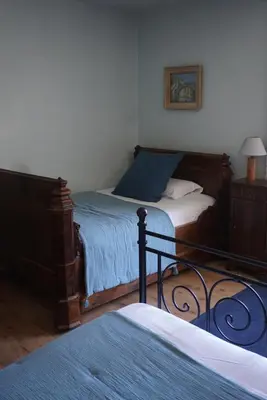 a bedroom with two twin beds and a lamp at La Bastide Saint Etienne in Cournanel
