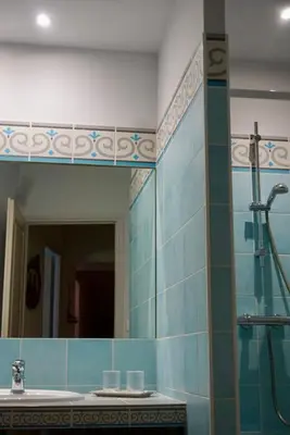 a bathroom with a mirror and a sink and a shower at La Bastide Saint Etienne in Cournanel