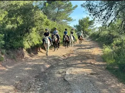 a group of people riding horses down a dirt road at La Villa du Menhir Gîte in Bize-Minervois
