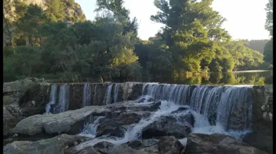 a waterfall on the side of a river at La Villa du Menhir Gîte in Bize-Minervois