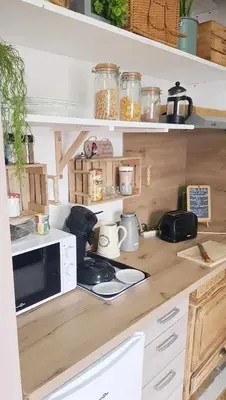 a kitchen counter with a microwave and a stove at La Villa du Menhir Gîte in Bize-Minervois