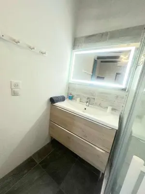a bathroom with a sink and a mirror at La Villa Du Menhir Chambre d'hôtes in Bize-Minervois