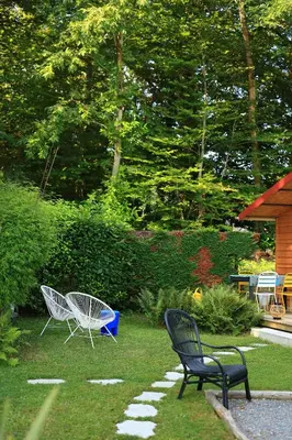 two chairs sitting on the grass next to sidx sidx sidx sidx sidx sidx at Chambre d'hôtes cosy Le Chalet -Tarn in Lacrouzette