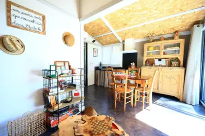 a kitchen and dining room with a table and chairs at Chambre d'hôtes cosy Le Chalet -Tarn in Lacrouzette