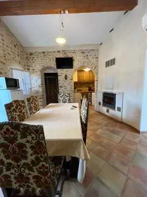 a kitchen and dining room with a table and chairs at Le Fenouillet Cottage proche des Grands Buffets in Narbonne