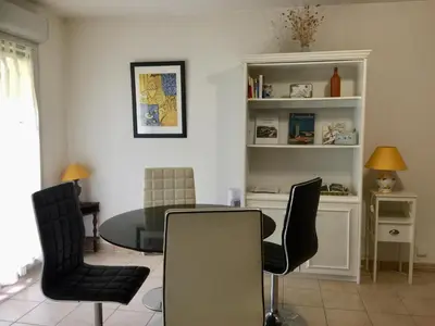 a dining room with a glass table and chairs at Les Capucins in Carcassonne
