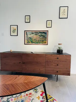 a living room with a wooden dresser against a wall at Charmant Studio proche Lac et Forêt in Carcassonne