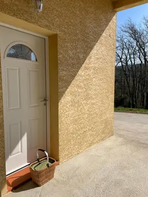 a door of a house with a basket next to it at Charmant Studio proche Lac et Forêt in Carcassonne