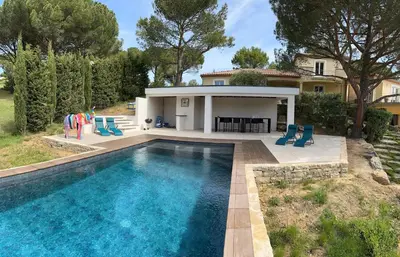 a swimming pool in front of a house at Charmant Studio proche Lac et Forêt in Carcassonne