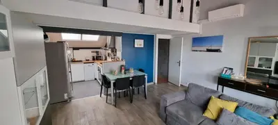 a living room with a couch and a table at Maison 3 pièces 5-7pers Vue sur port, garage, clim in Gruissan