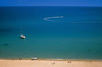 a boat in the water on a beach at Gite Joséphine dans une tour médiévale - Carcassonne in Saint-Hilaire