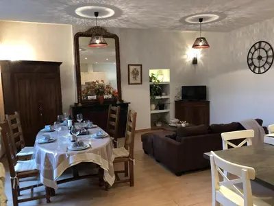 a living room with a table and a couch at Gite Joséphine dans une tour médiévale - Carcassonne in Saint-Hilaire