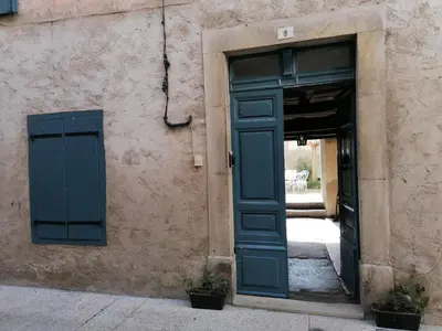 an entrance to a building with a blue door at Gite Joséphine dans une tour médiévale - Carcassonne in Saint-Hilaire