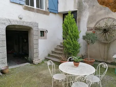 a table and chairs in front of a building at Gite Joséphine dans une tour médiévale - Carcassonne in Saint-Hilaire