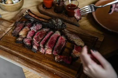 a bunch of meat on a wooden cutting board at Château Capitoul in Narbonne