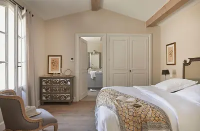 a bedroom with a large bed and a mirror at Château Capitoul in Narbonne