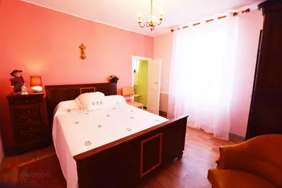 a bedroom with a large bed and a window at La Petite Maison in Cesseras