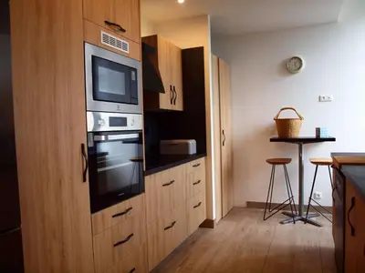 a kitchen with a stove and a microwave at Gites de l'écluse - La Côte de l'Or in Sallèles-dʼAude