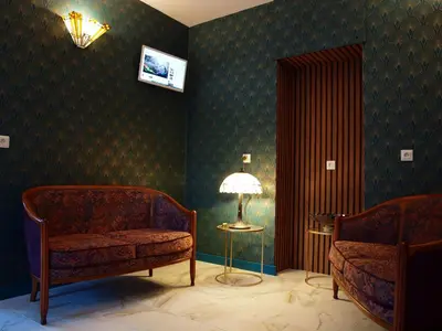 a room with two chairs and a table and a lamp at Gites de l'écluse - La Côte de l'Or in Sallèles-dʼAude