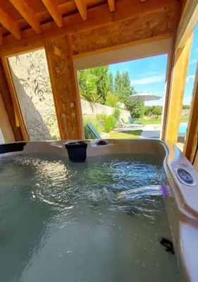 a bath tub filled with water in a house at Gites de l'écluse - La Côte de l'Or in Sallèles-dʼAude