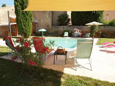 a swimming pool with chairs and a table next to it at Gites de l'écluse - La Côte de l'Or in Sallèles-dʼAude