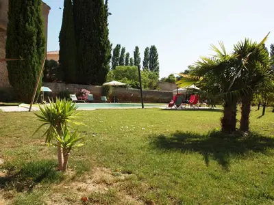 a park with two palm trees in the grass at Gites de l'écluse - La Côte de l'Or in Sallèles-dʼAude